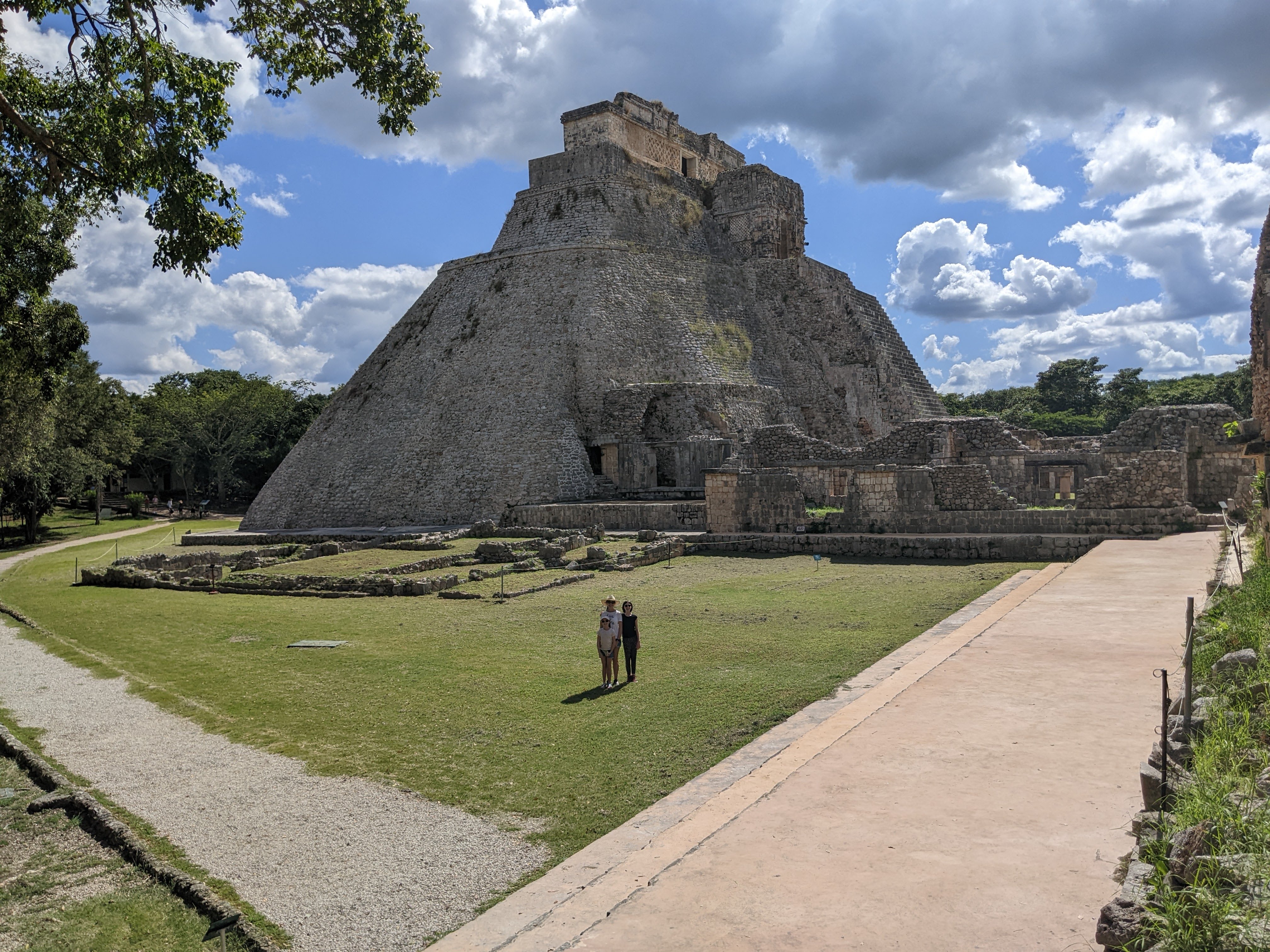 Uxmal-pyramid-ancient-ruins-of-Mayan-city-in-background-kids-in-front.
